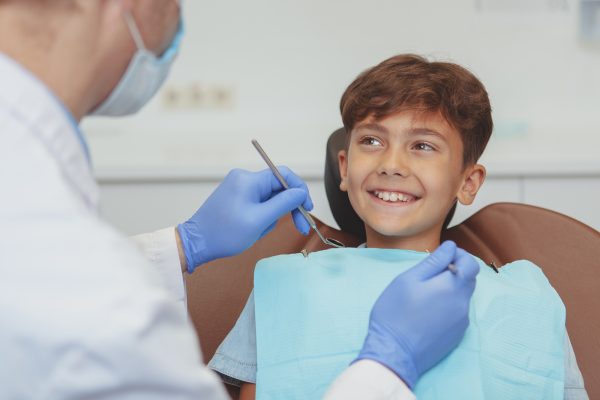 A photograph of a happy child receiving dental treatment.