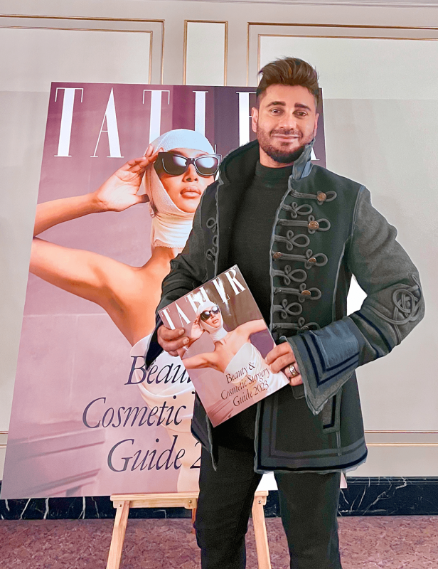 Photo of Dr Bob Khanna in front of the Tatler Beauty and Cosmetic Surgery Guide 2023